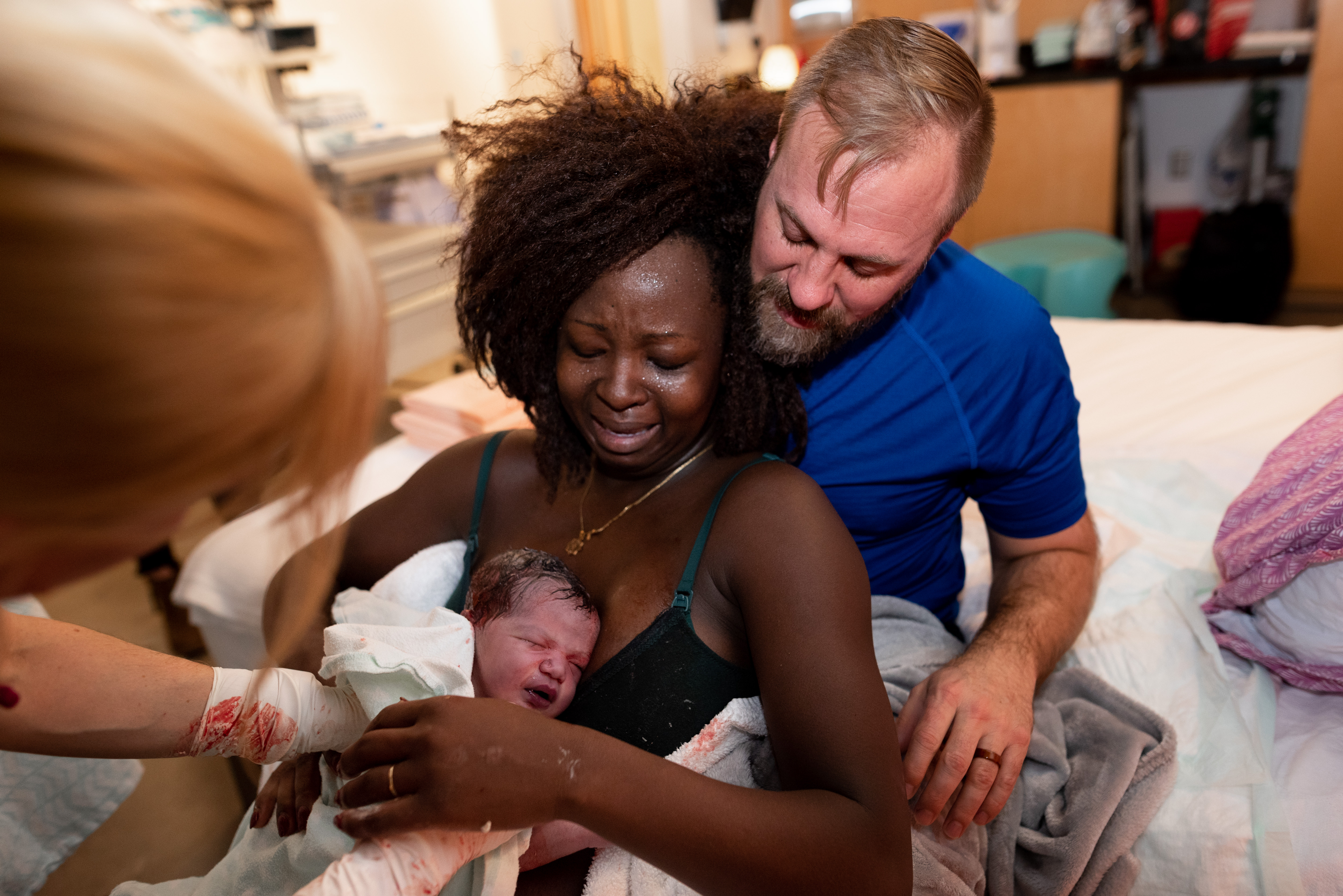 Mother and father cry as they meet their new son after giving birth
