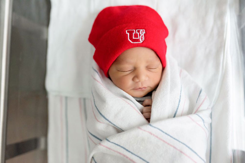 newborn-with-red-university-of-utah-beanie