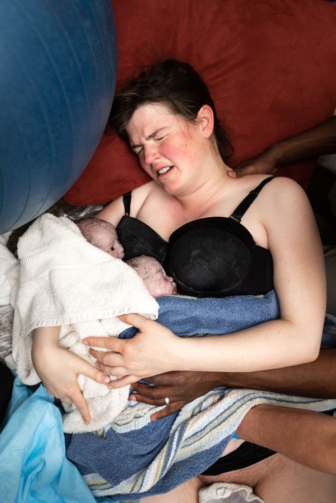 Both twins lie on mothers chest after home birth in Utah