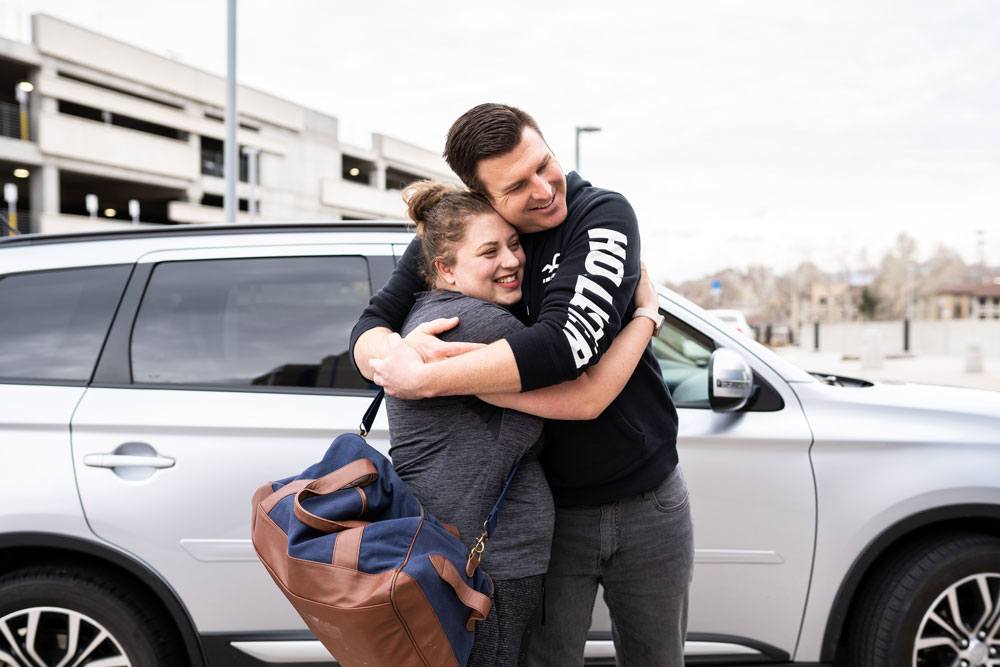 Doula and husband hug at the arrival to the hospital