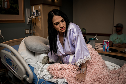 Mom sits in a hospital bed while she labors
