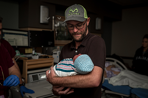 New dad holds is son who was just born