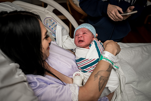 Mom hold her newborn son after birth
