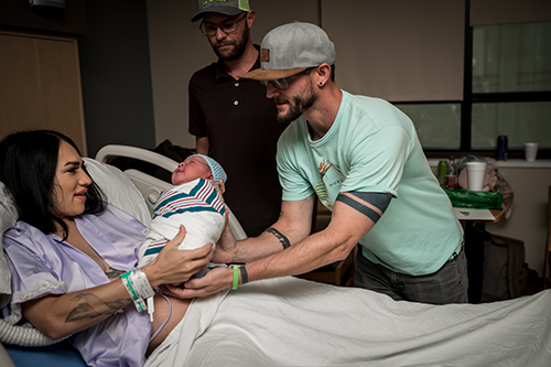 Mom hands newborn son to adoptive dads
