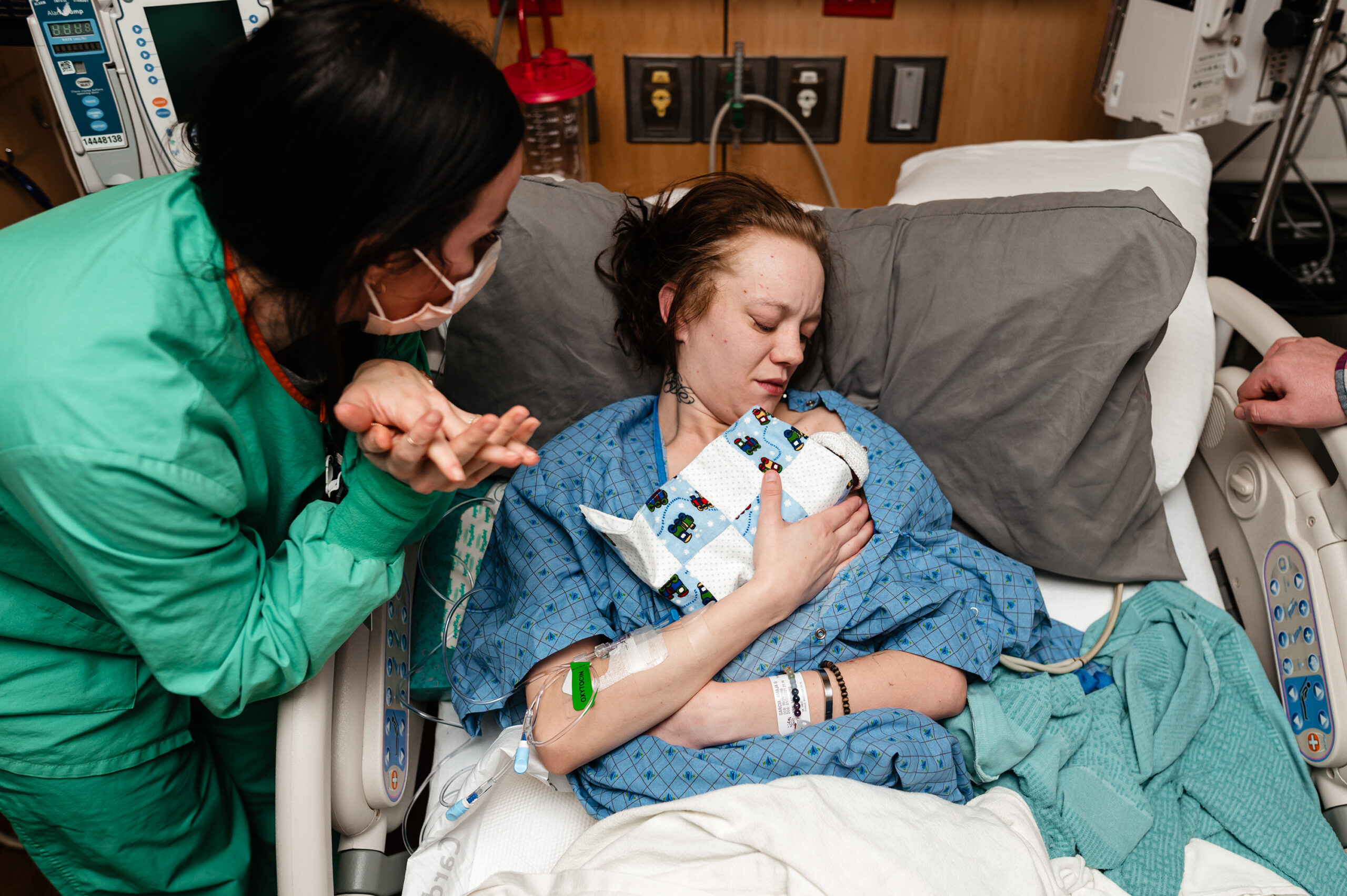 Mother holds her son who passed away at 19 weeks gestation in a hospital bed